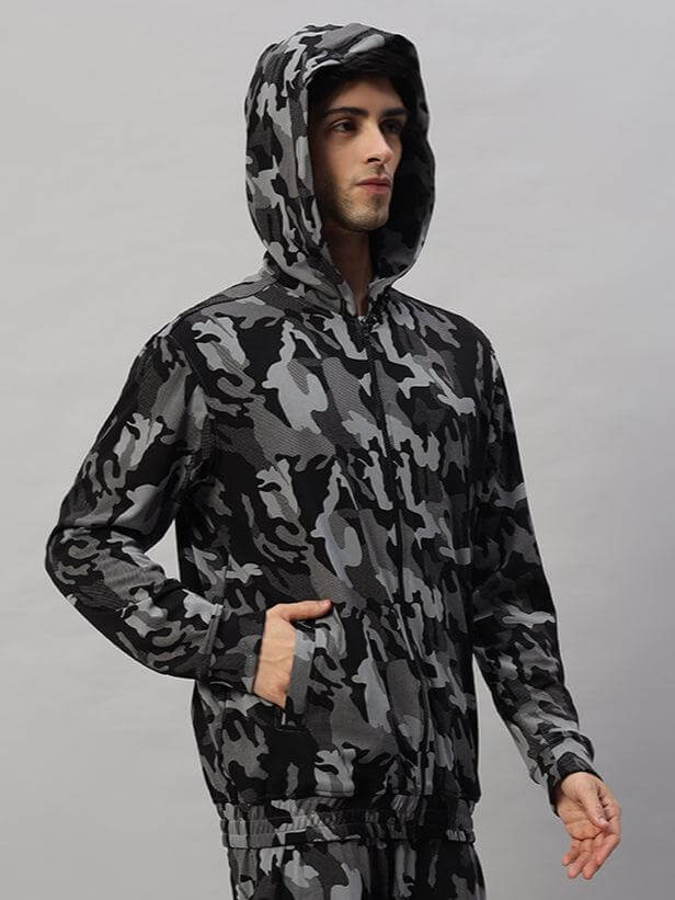 Model wearing a Trench Camouflage Jacket in Camo Navy by DUDS, featuring a hood and long sleeves, ideal for outdoor style and comfort.