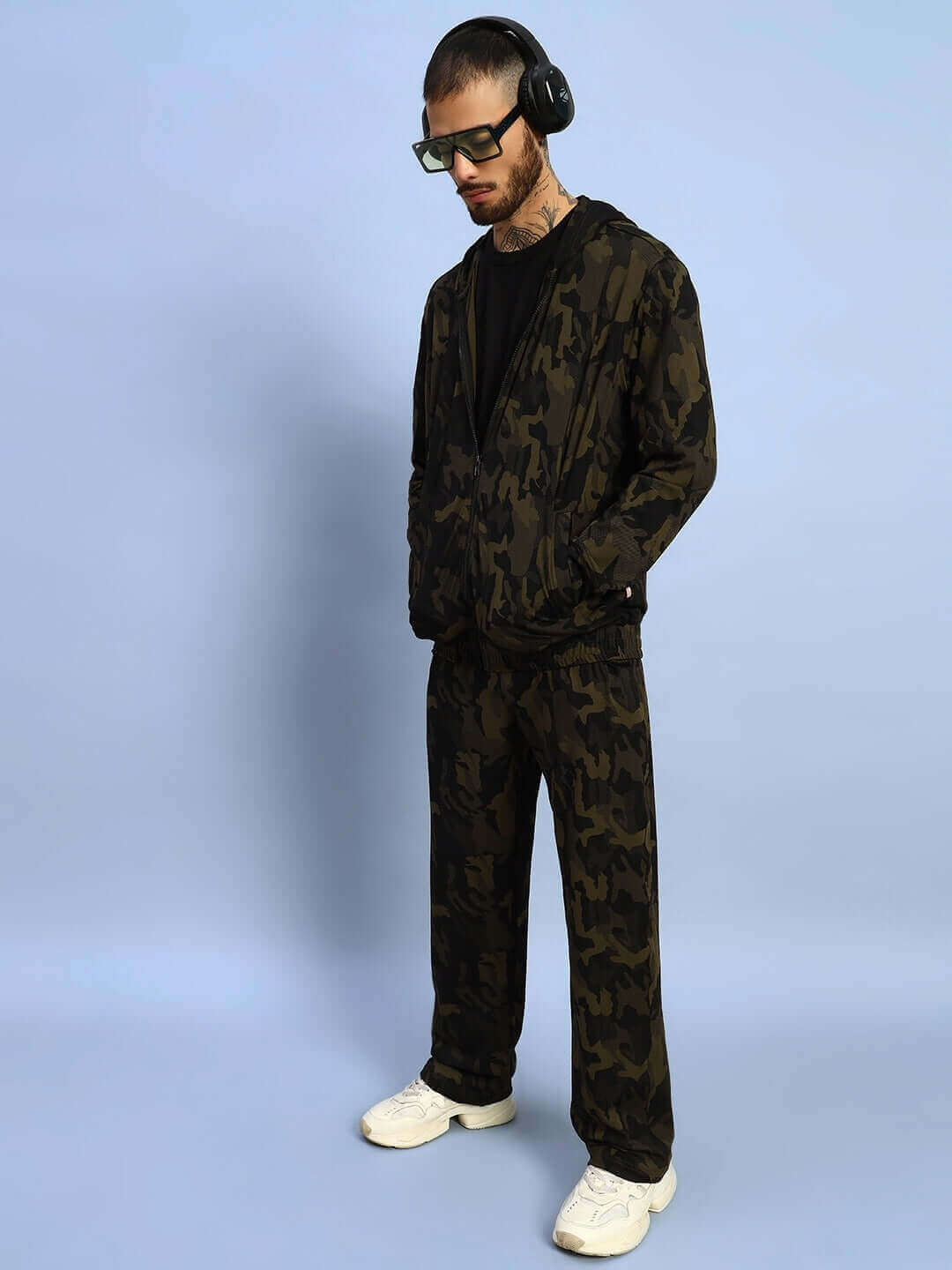 Person wearing Trench Relaxed Pant Jogger in camo green, featuring made-to-order craftsmanship by DUDS tailors.