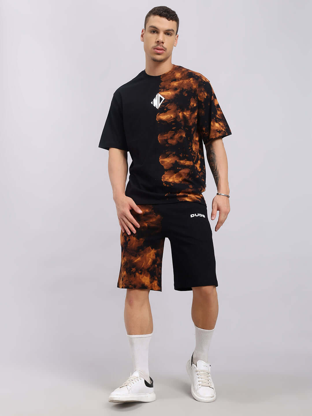 Black tie-dye co-ord set made from premium cotton terry fabric, featuring a t-shirt and shorts, modeled by a person standing against a neutral background.