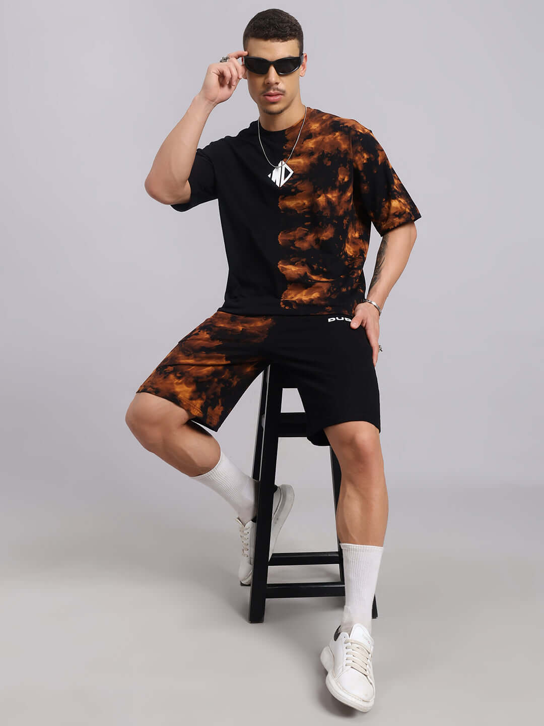 Model wearing Trickster Tie-Dye Co-Ord Set in black, featuring premium cotton French Terry Lycra, styled with white sneakers.