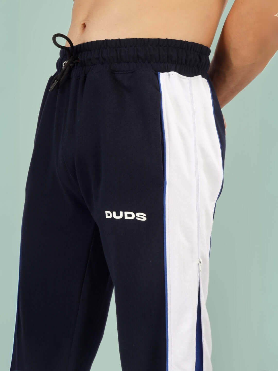 Black TRIUMPH joggers with white and blue side zippers, featuring DUDS logo, designed for custom fit options.