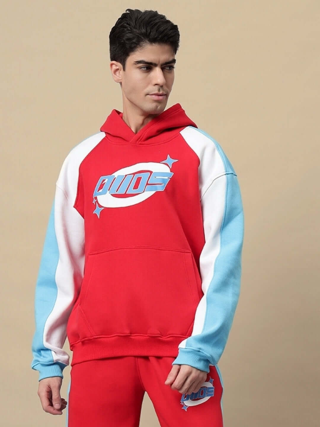 Model wearing TRUNKIT FLEECE COLORBLOCK HOODIE RED with bold colorblock design, showcasing trendy streetwear style.