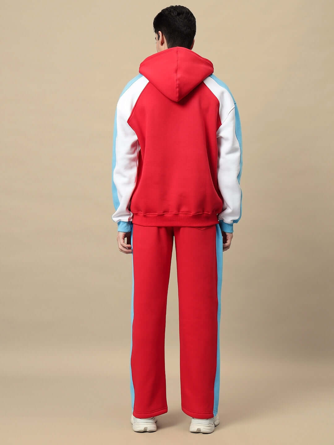 Back view of Trunkit Fleece Colorblock Cargo Pant showcasing bold red and blue design with spacious side pockets and streetwear style.