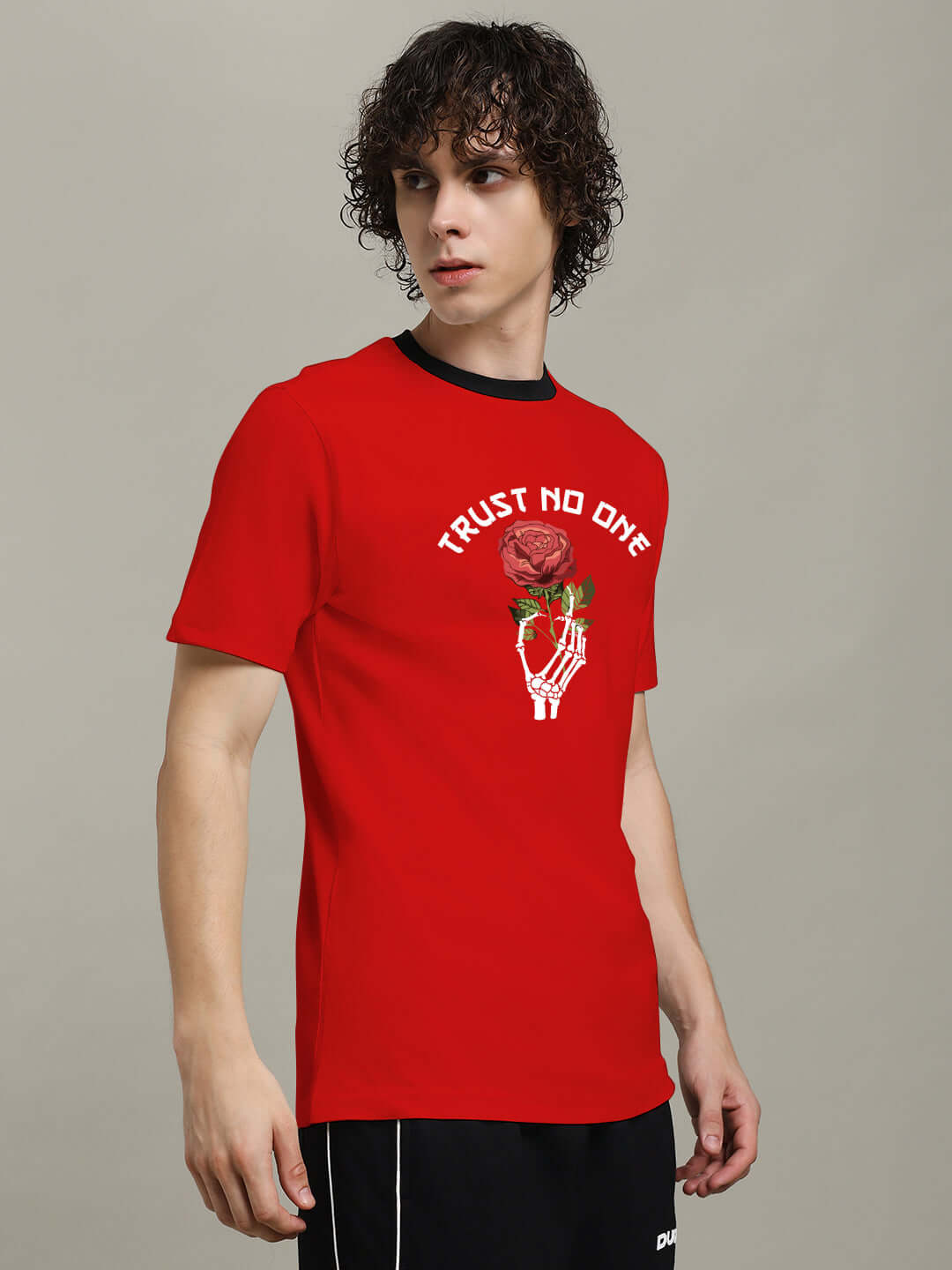 Person wearing TRUST NO ONE REGULAR FIT PRINTED T-SHIRT RED with graphic design