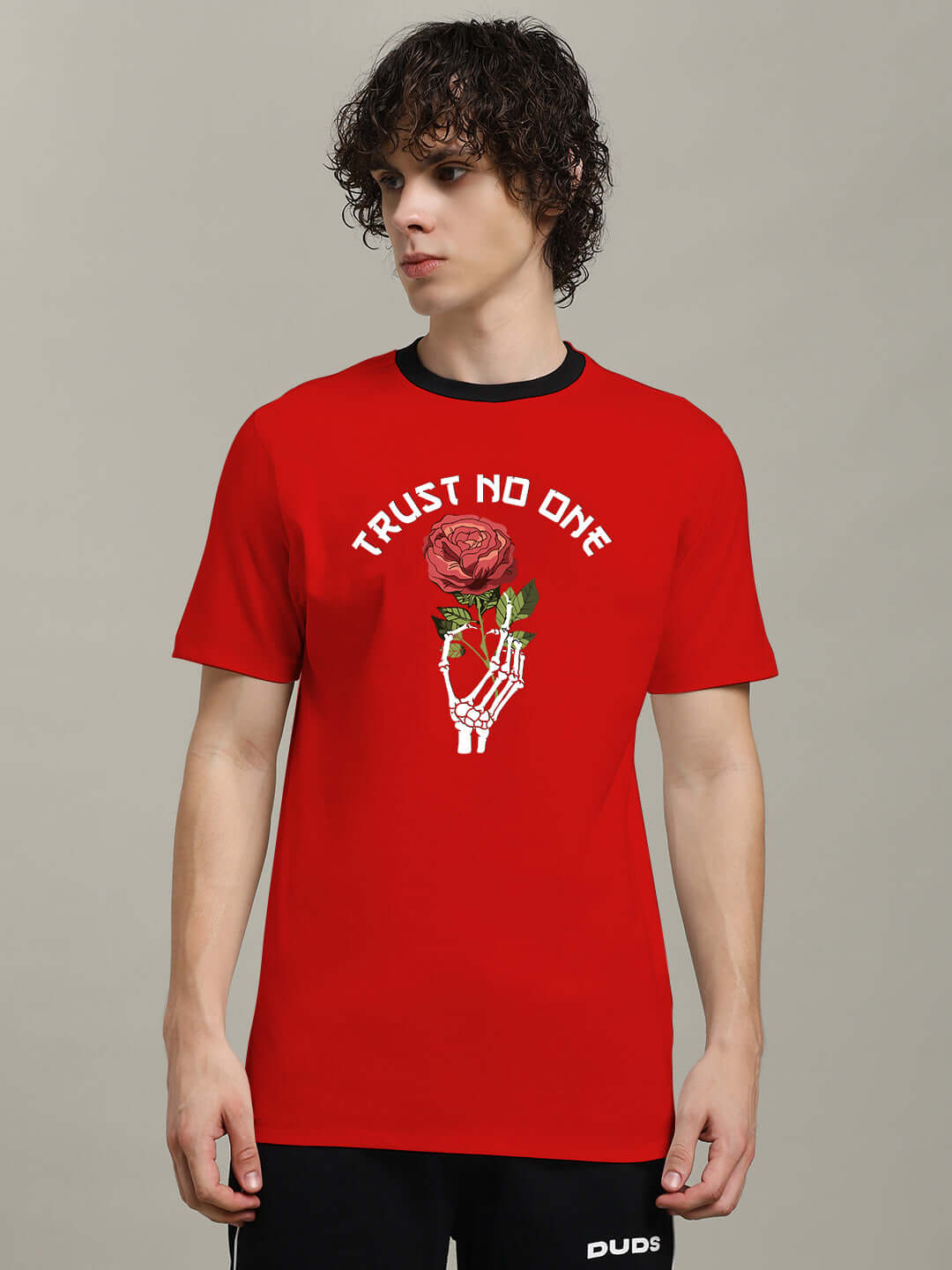 Red TRUST NO ONE printed t-shirt with rose and skeleton hand design, 100% cotton, regular fit, worn by model, premium quality fabric.