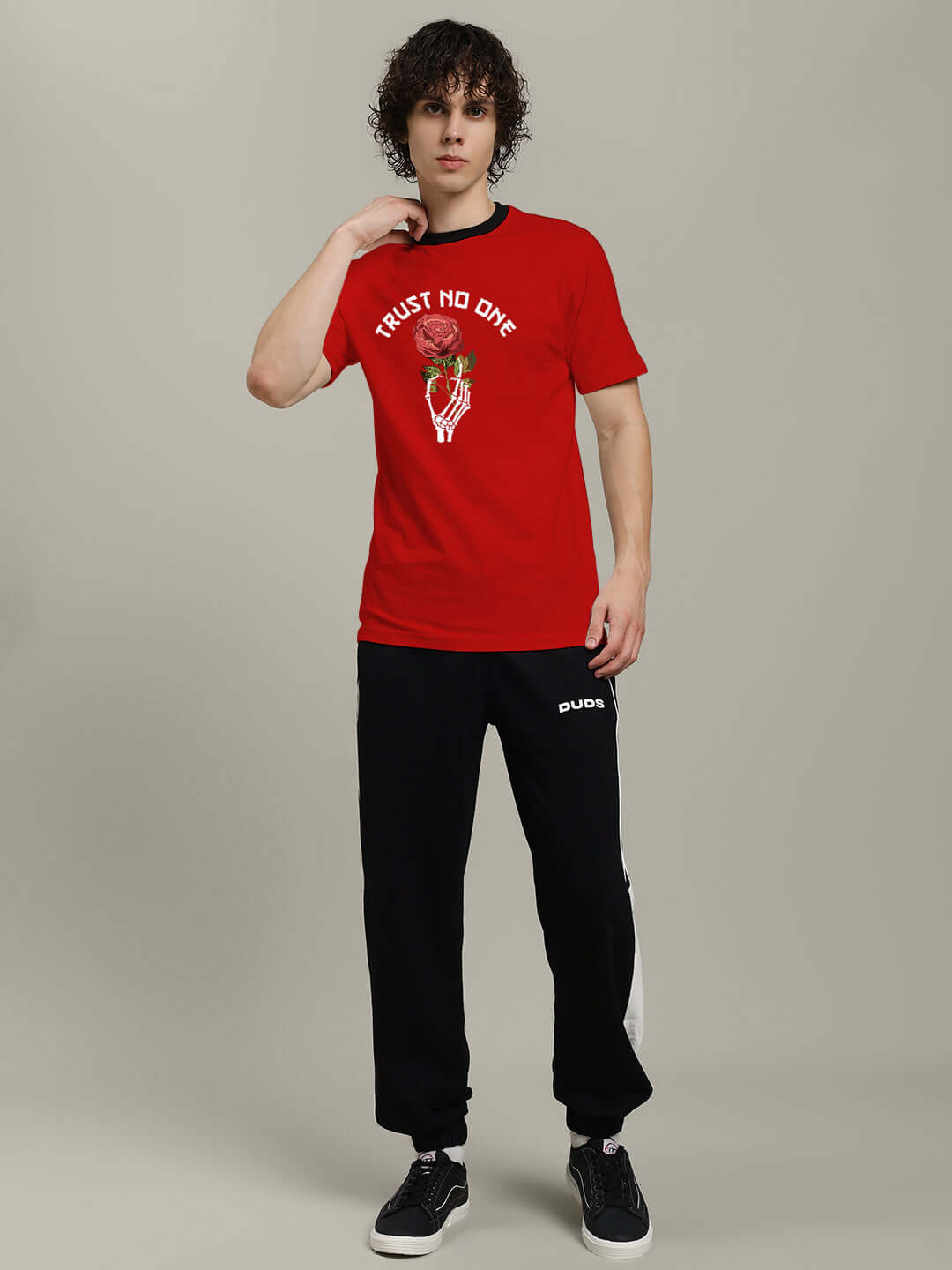 Model wearing TRUST NO ONE REGULAR FIT PRINTED T-SHIRT RED with edgy graphic, showcasing bold style and attitude.