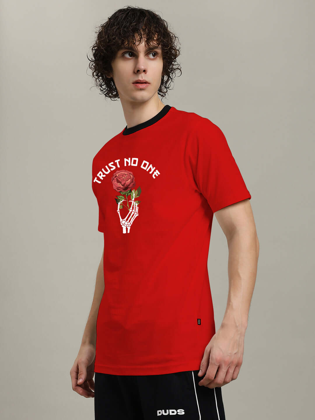 Man wearing TRUST NO ONE REGULAR FIT PRINTED T-SHIRT RED with edgy graphic print, showcasing bold style and attitude.