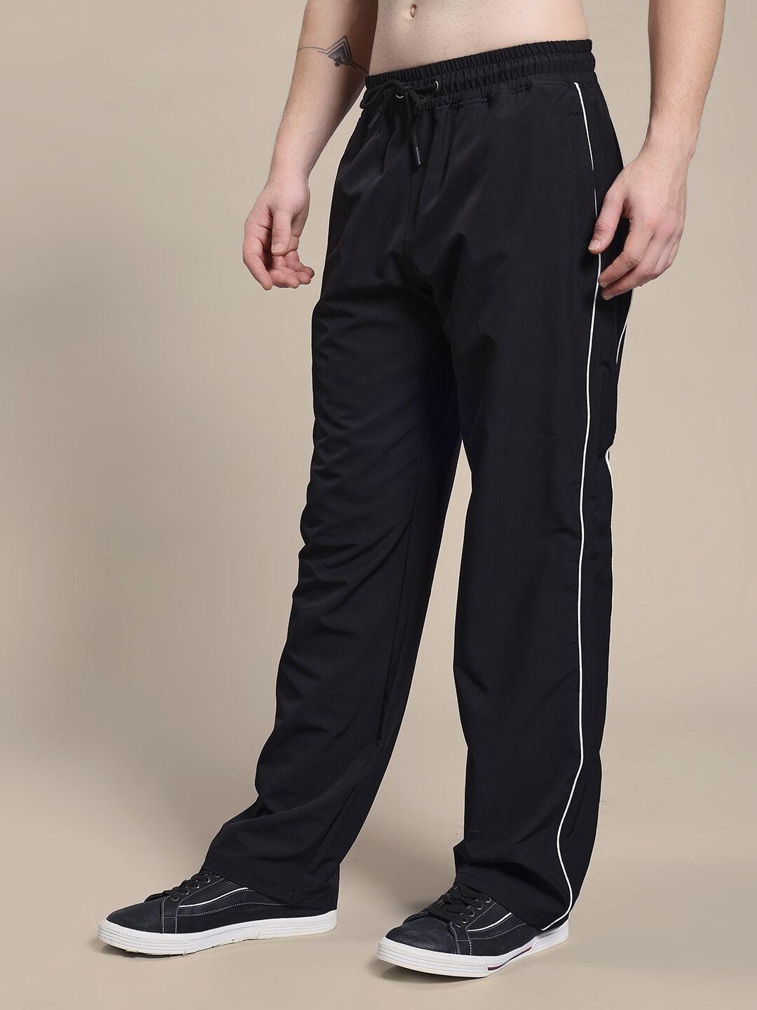 Person wearing TURBO TRACK RELAXED-FIT JOGGERS BLACK in a stylish pose, showcasing the relaxed fit and modern design.