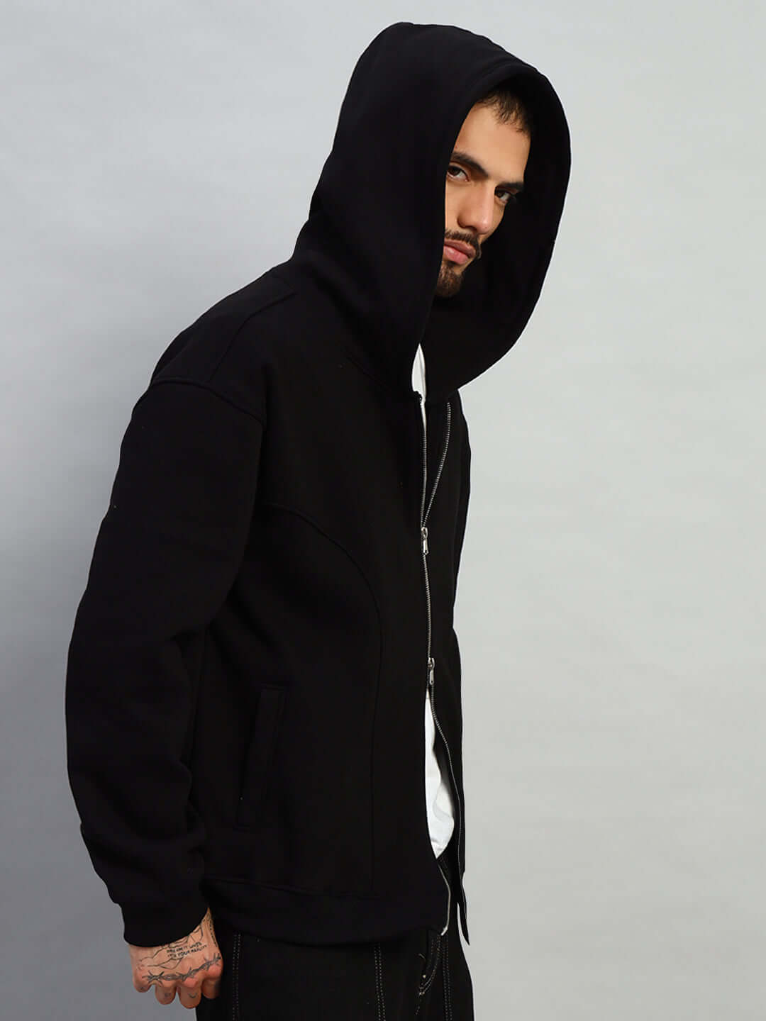 Model wearing WEARDUDS TWO FOLD ZIPPER HOODIE BLACK, stylish and comfortable hoodie with a front zipper.
