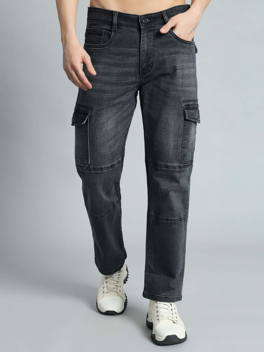 Man wearing grey TYRO relaxed denim cargo pants from DUDS, featuring a comfortable fit and multiple pockets, styled with white sneakers.