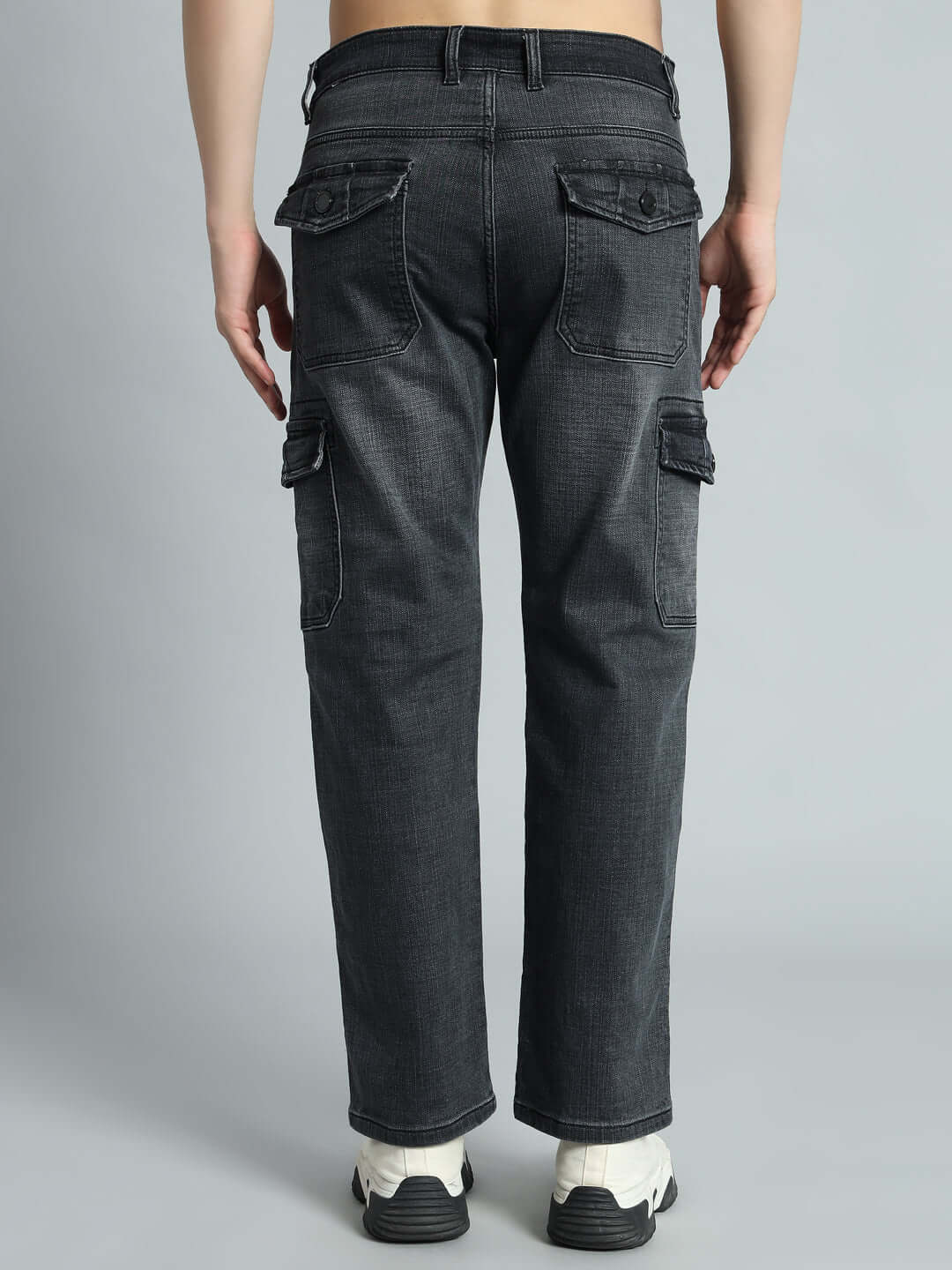 Back view of TYRO relaxed grey denim cargo pants showcasing pockets and stitching detail, designed by DUDS. Custom fit available.