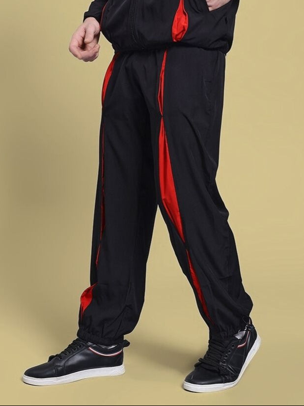 Unison Relaxed-Fit Joggers Black Red for kids, showcasing stylish design with vibrant red stripe on black fabric, perfect for active wear.