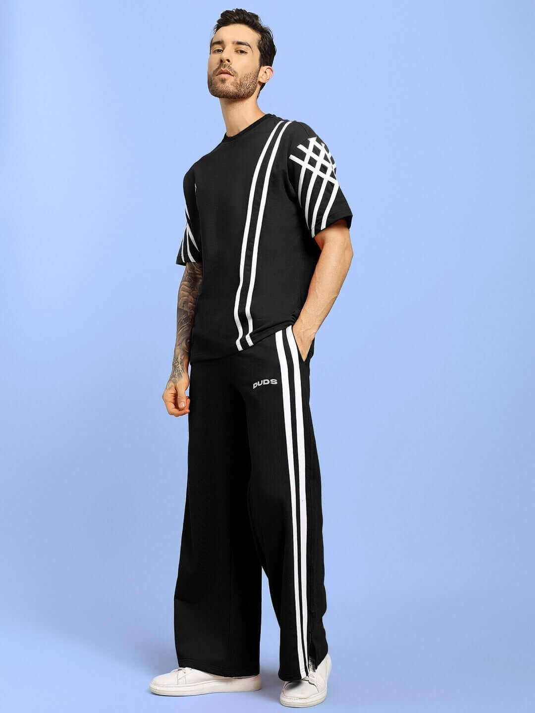 Model wearing a black United Stripe Co-Ord set made of premium cotton French terry lycra with white stripes, perfect for casual wear.
