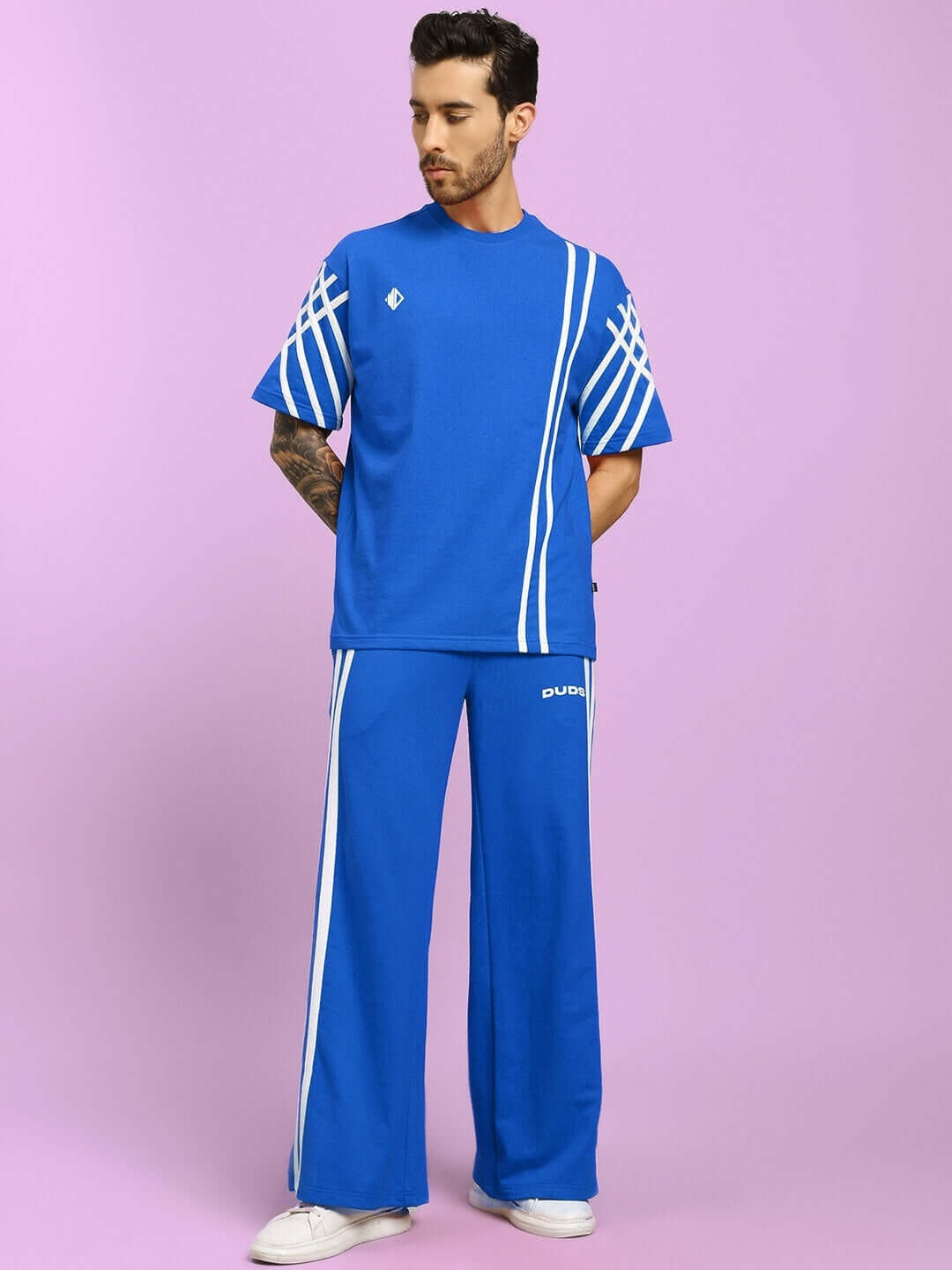 Model wearing blue United Stripe Co-ord Set with white patterns, made from premium cotton terry fabric.