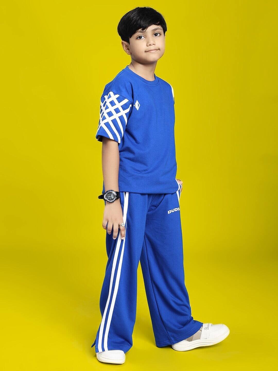 Child wearing UNITED STRIPE CO-ORD SET FOR BOYS GIRLS BLUE against yellow background