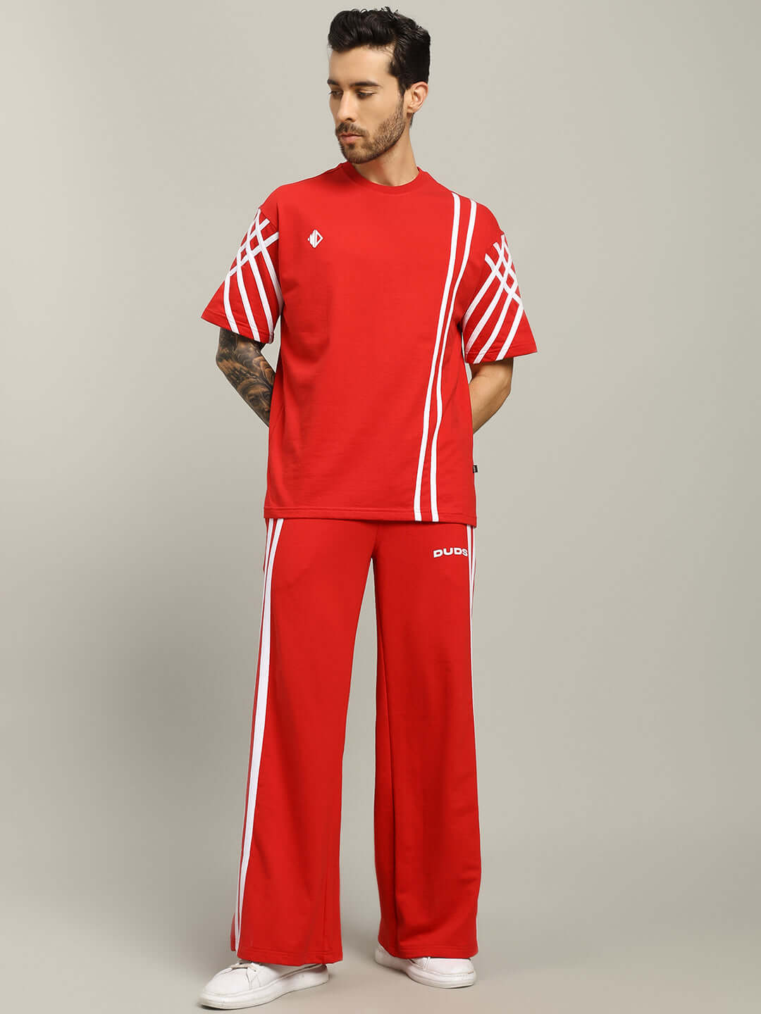 Red UNITED STRIPE CO-ORD SET with white stripes, made from premium cotton French terry fabric, modeled on a man, perfect for stylish comfort.