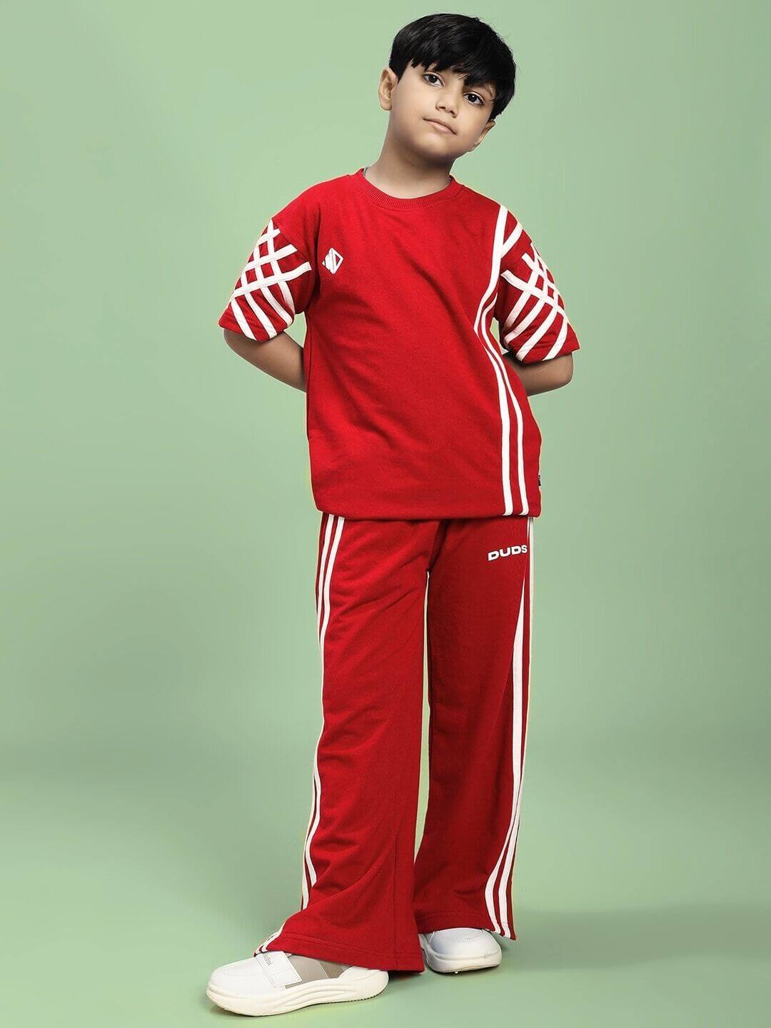 Child wearing UNITED STRIPE JOGGER FOR BOYS AND GIRLS RED with sporty stripe accents, ideal for casual and athletic wear.