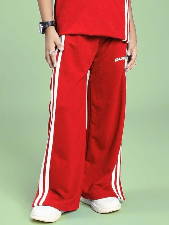 Child wearing UNITED STRIPE JOGGER FOR BOYS AND GIRLS RED with sporty details, ideal for active wear and stylish comfort.