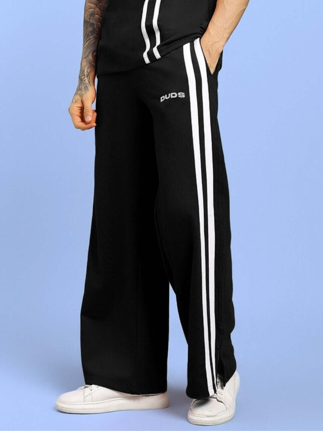 Black UNITED STRIPE JOGGERS by DUDS featuring white side stripes, worn with white sneakers; made-to-order with custom fit options.