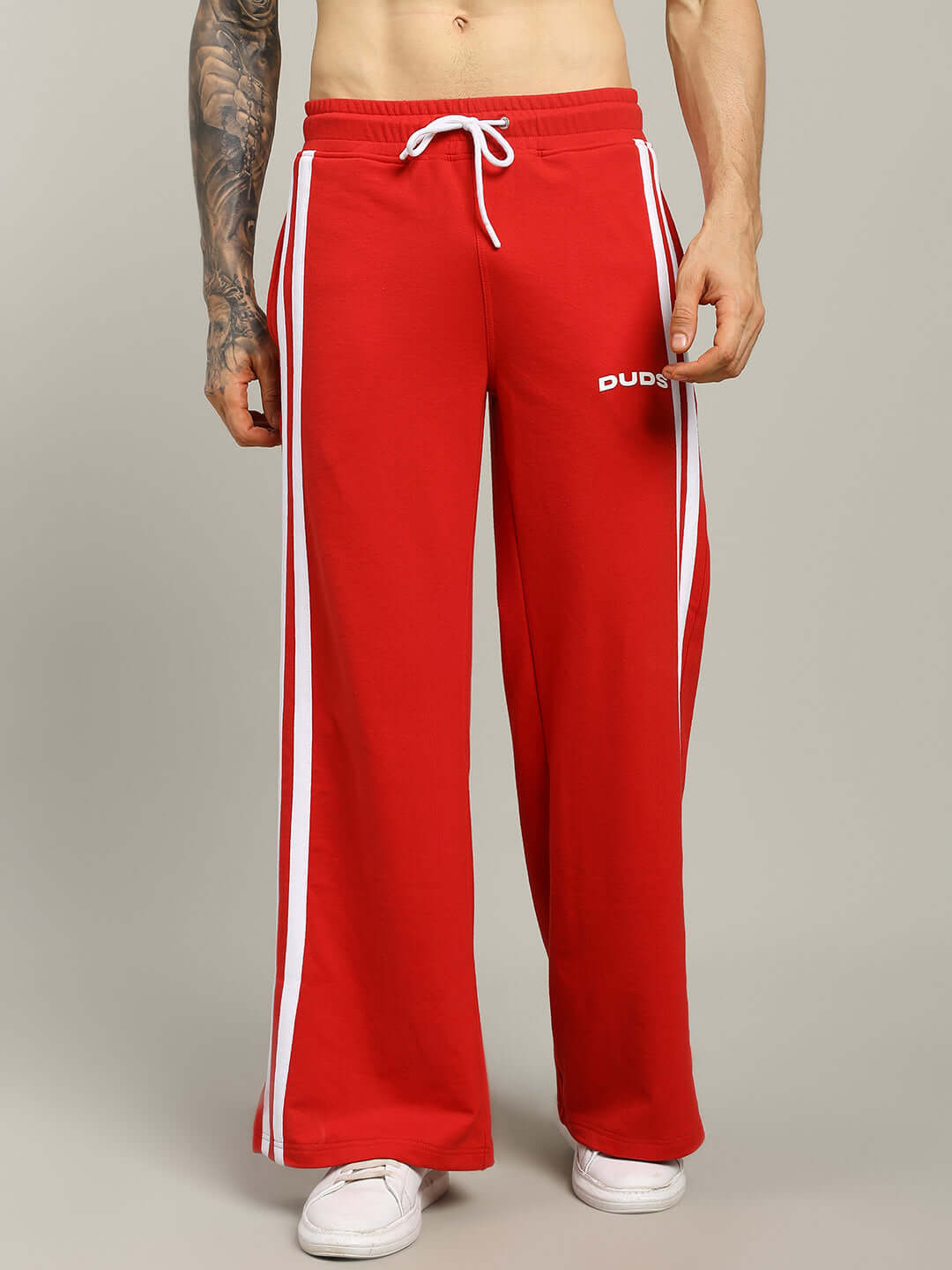 Red United Stripe Joggers by DUDS, featuring white side stripes and drawstring, made to order by experienced tailors.