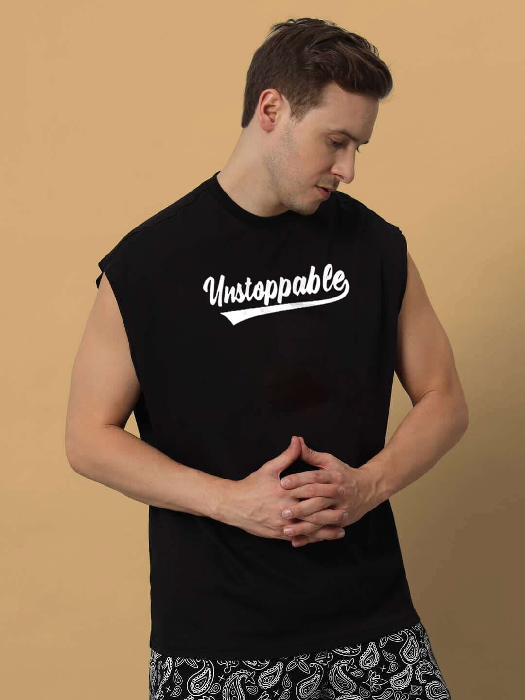 Male model wearing black Unstoppable gym t-shirt, customizable fit option, ideal for workouts, front view.