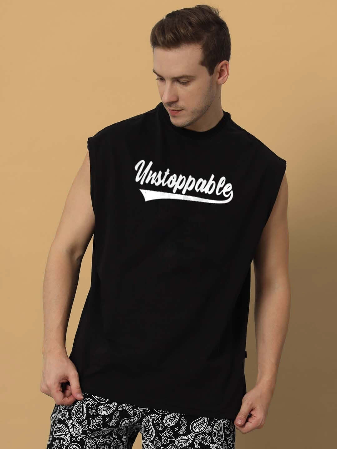 Black "Unstoppable" gym t-shirt, sleeveless, worn by a model, showcasing comfortable and customizable fit options.