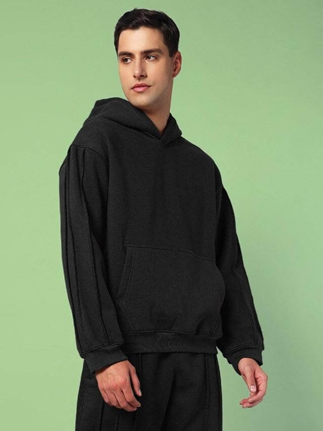 Man wearing URBAN SOLID PLATED FLEECE HOODIE BLACK in premium fleece fabric