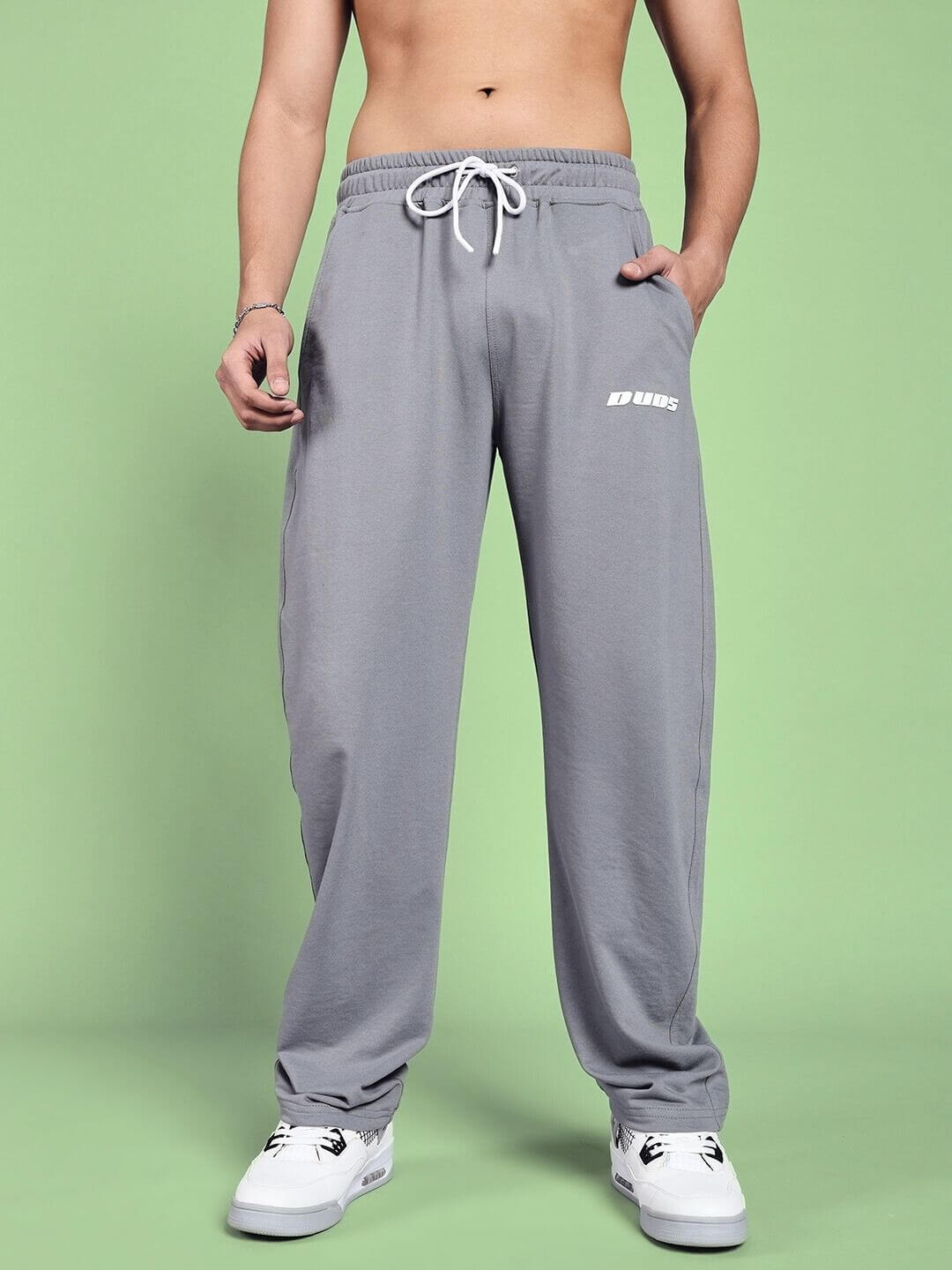 Vanilla Relaxed-Fit Grey Joggers by DUDS displayed against a green background, showcasing comfortable and stylish design.