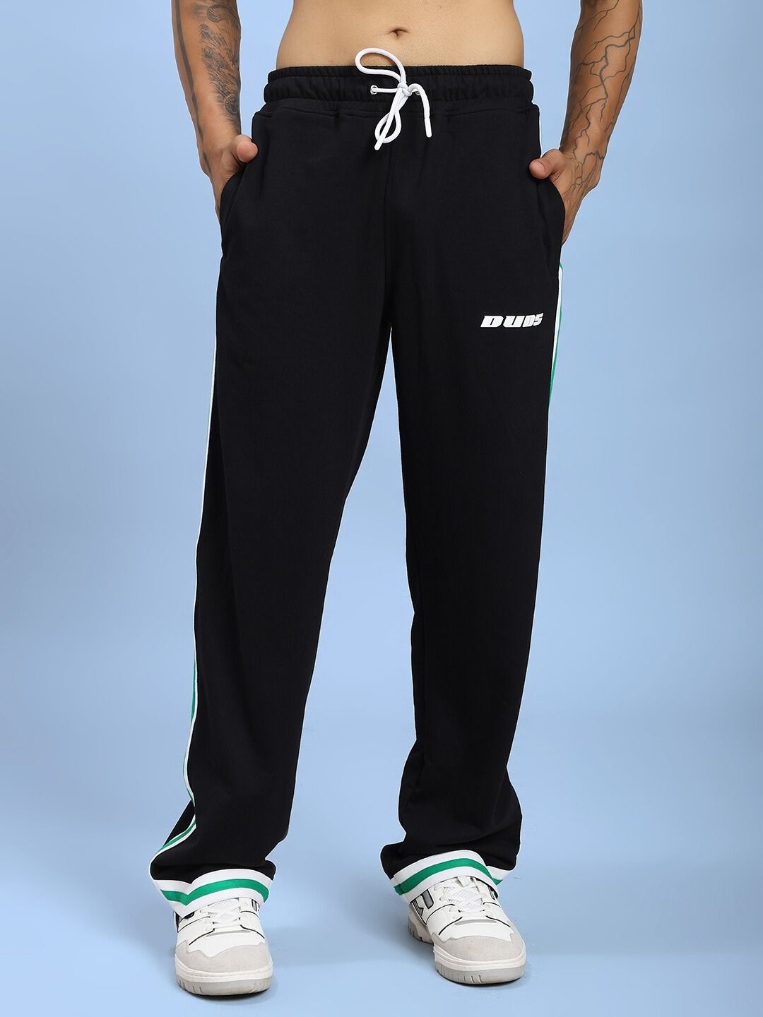 Model wearing VELO GREEN STRIPE RELAXED FIT JOGGER BLACK showcasing sporty design with green stripes on leg, perfect for casual and athletic wear.