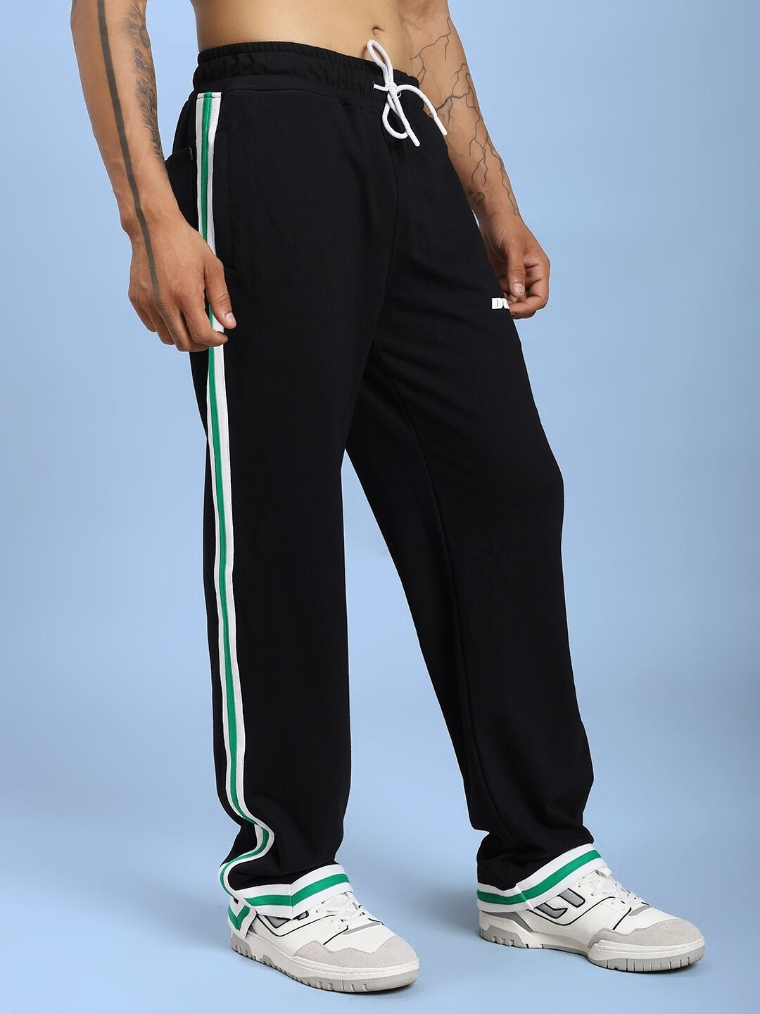 Model wearing VELO GREEN STRIPE RELAXED FIT JOGGER BLACK with green stripe detailing, showcasing sporty style and comfort.