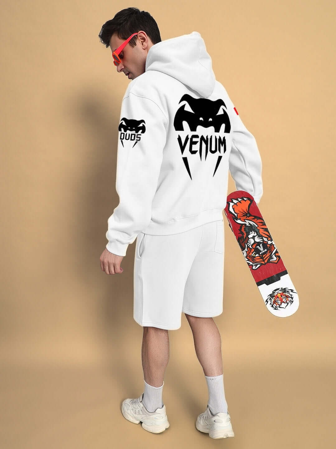 Person wearing WEARDUDS VENUM FLEECE CO-ORD WHITE with skateboard, showcasing the custom fit hoodie and shorts.