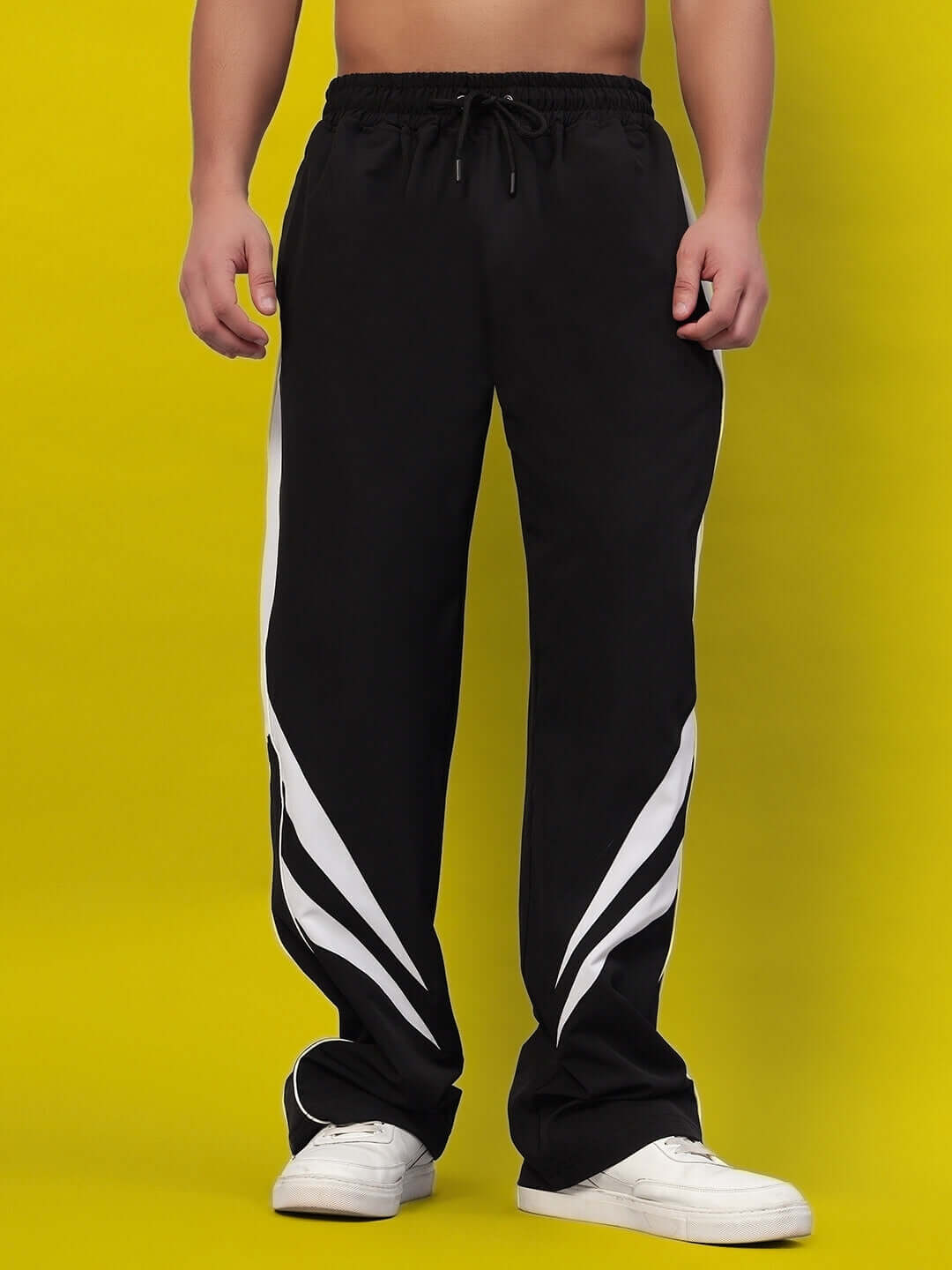 Model wearing black versatile parachute cargo pants with white stripes, perfect for customizable fit options, available for prepaid orders.