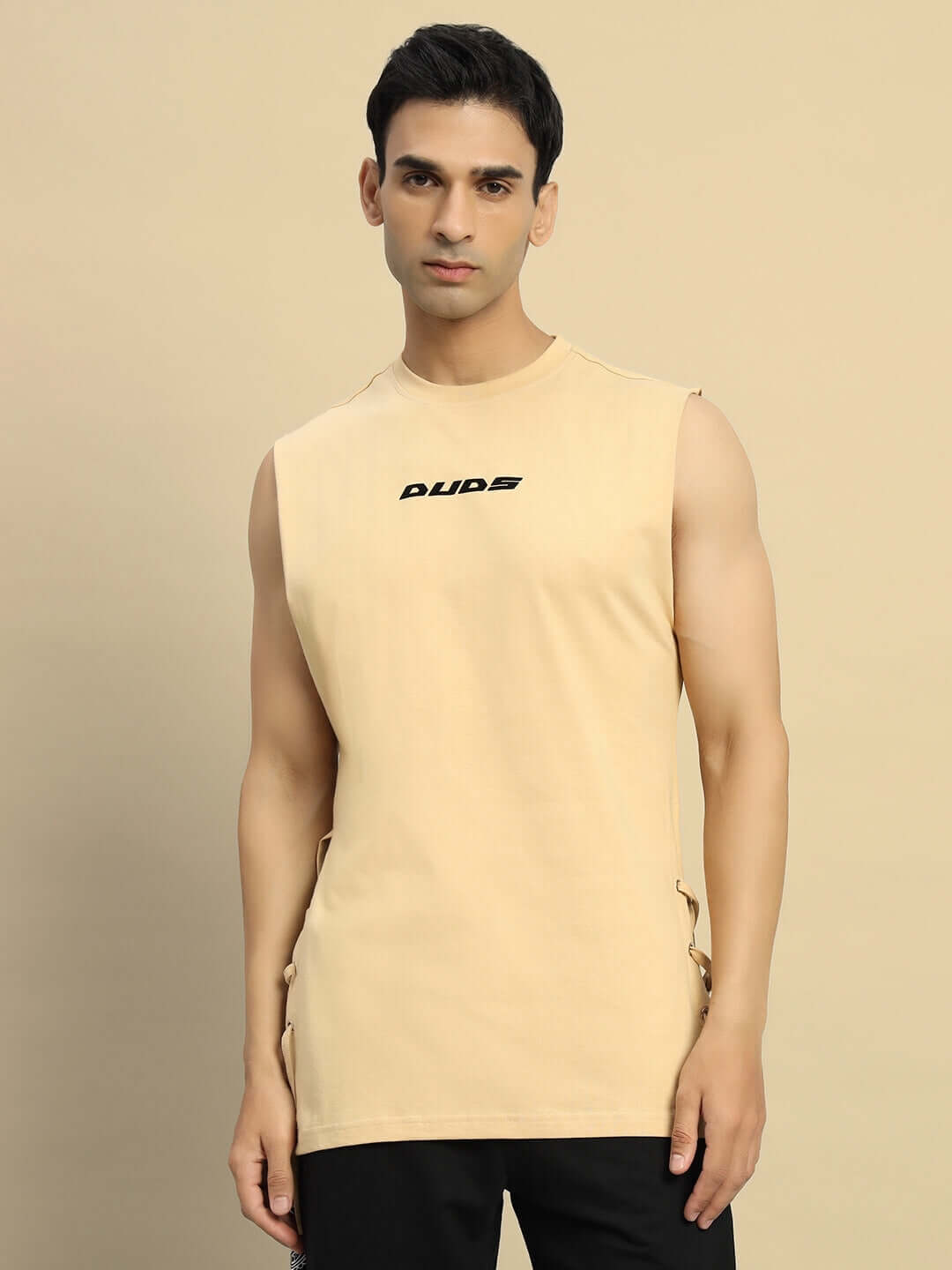 Model wearing Vertex Relaxed Fit Sleeveless T-Shirt in beige, customizable size with Custom Fit option, handmade and pre-order only.