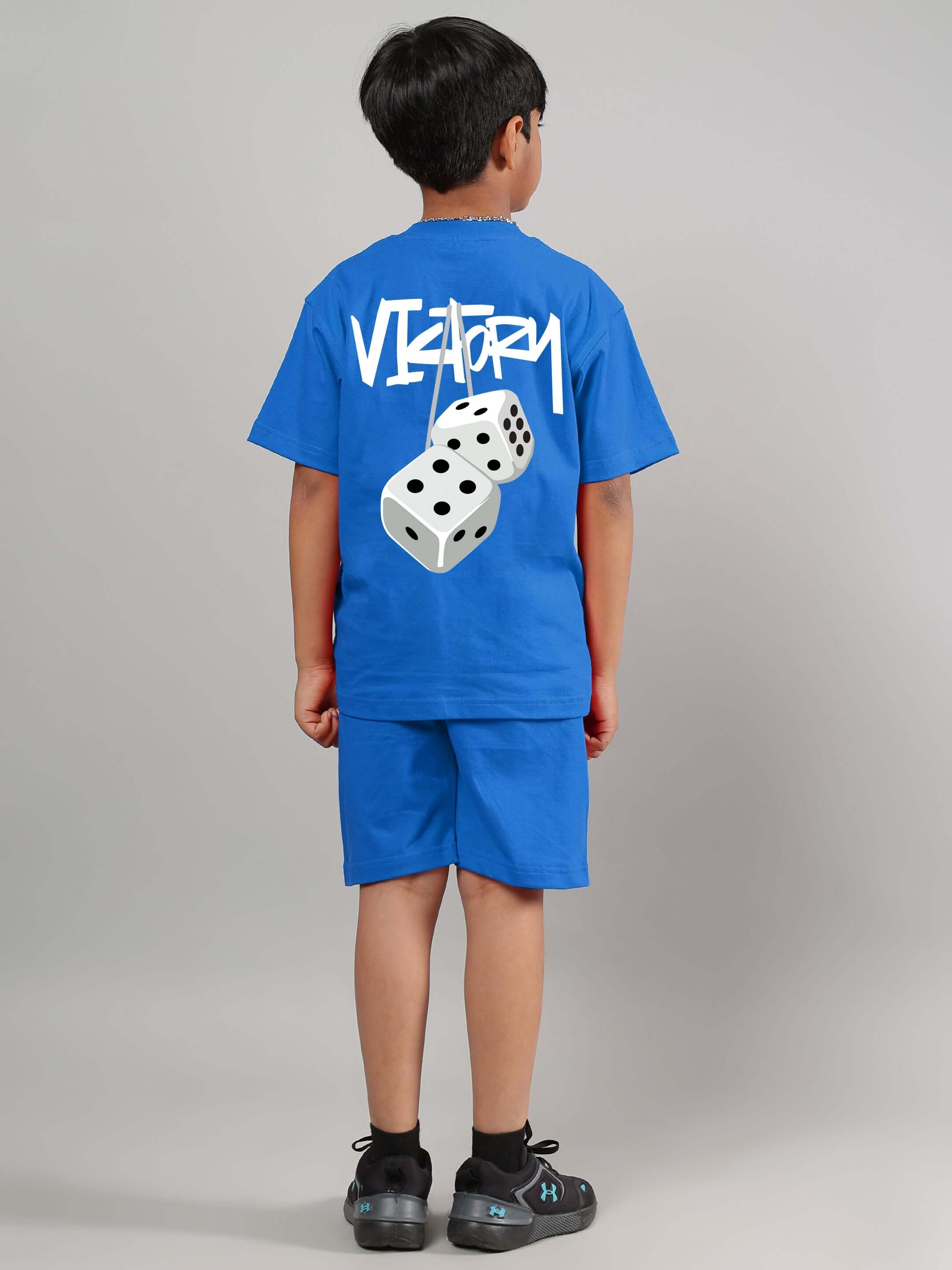 Child wearing blue Victory co-ord set from DUDS, featuring dice graphic on the back. Custom sizes available. Made to order.