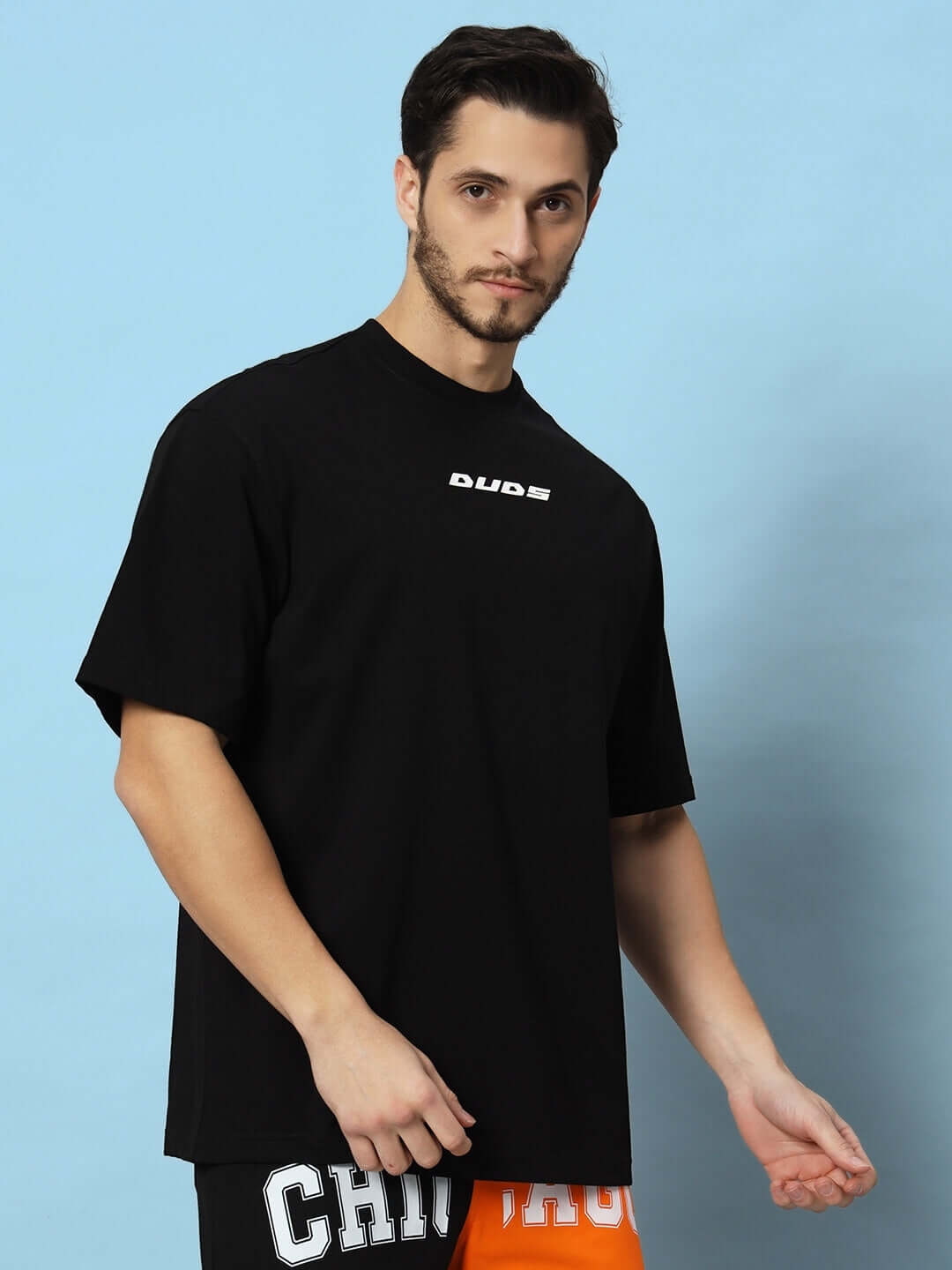 Model wearing Victory Over-sized T-shirt in black, showcasing relaxed fit. Suitable for custom fit options available on prepaid orders.