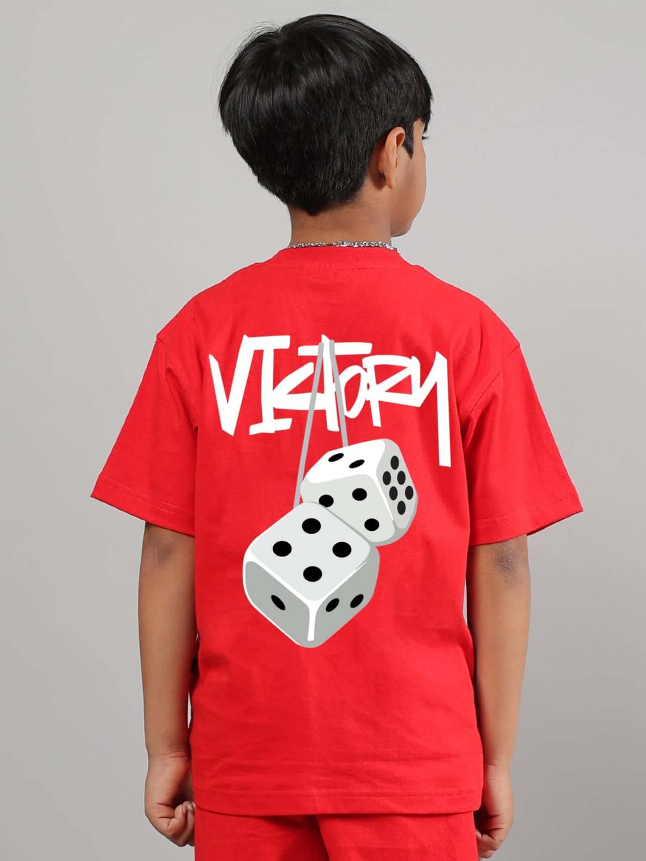 Child wearing red "Victory" T-shirt with dice graphic on back, designed for boys and girls by DUDS. Custom fit available.