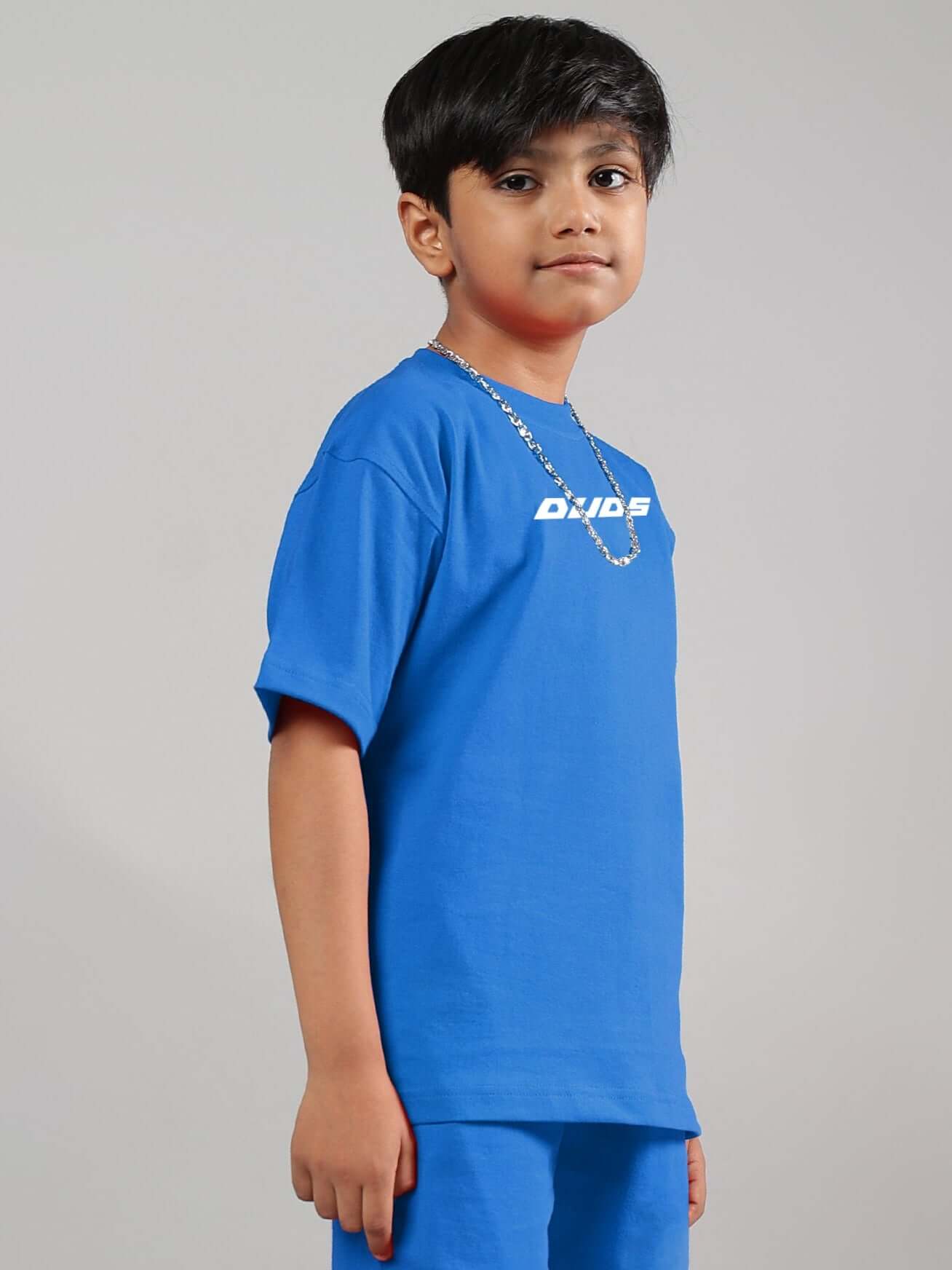Child wearing a Victory T-shirt in R-Blue by DUDS, showcasing casual style for boys and girls. Available with custom fit options.