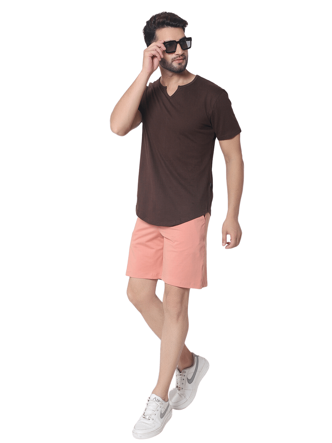 Man wearing a VIKING regular fit brown t-shirt made of 100% cotton, paired with peach shorts, showcasing casual summer fashion.