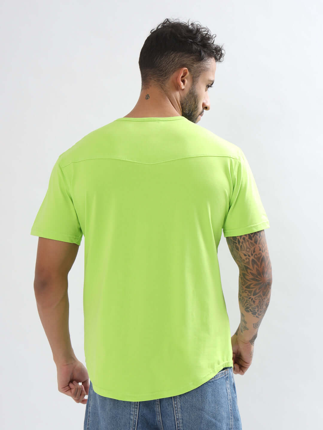 Back view of a man wearing a neon green VIKING regular fit t-shirt in heavy cotton fabric, showcasing tattooed arm detail.