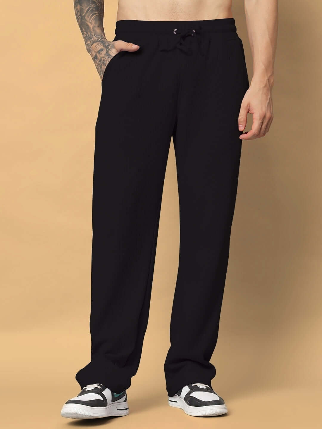 Black unisex relaxed fit joggers with elasticated waistband and drawstring, made of premium heavy gauge 100% cotton waffle fabric.