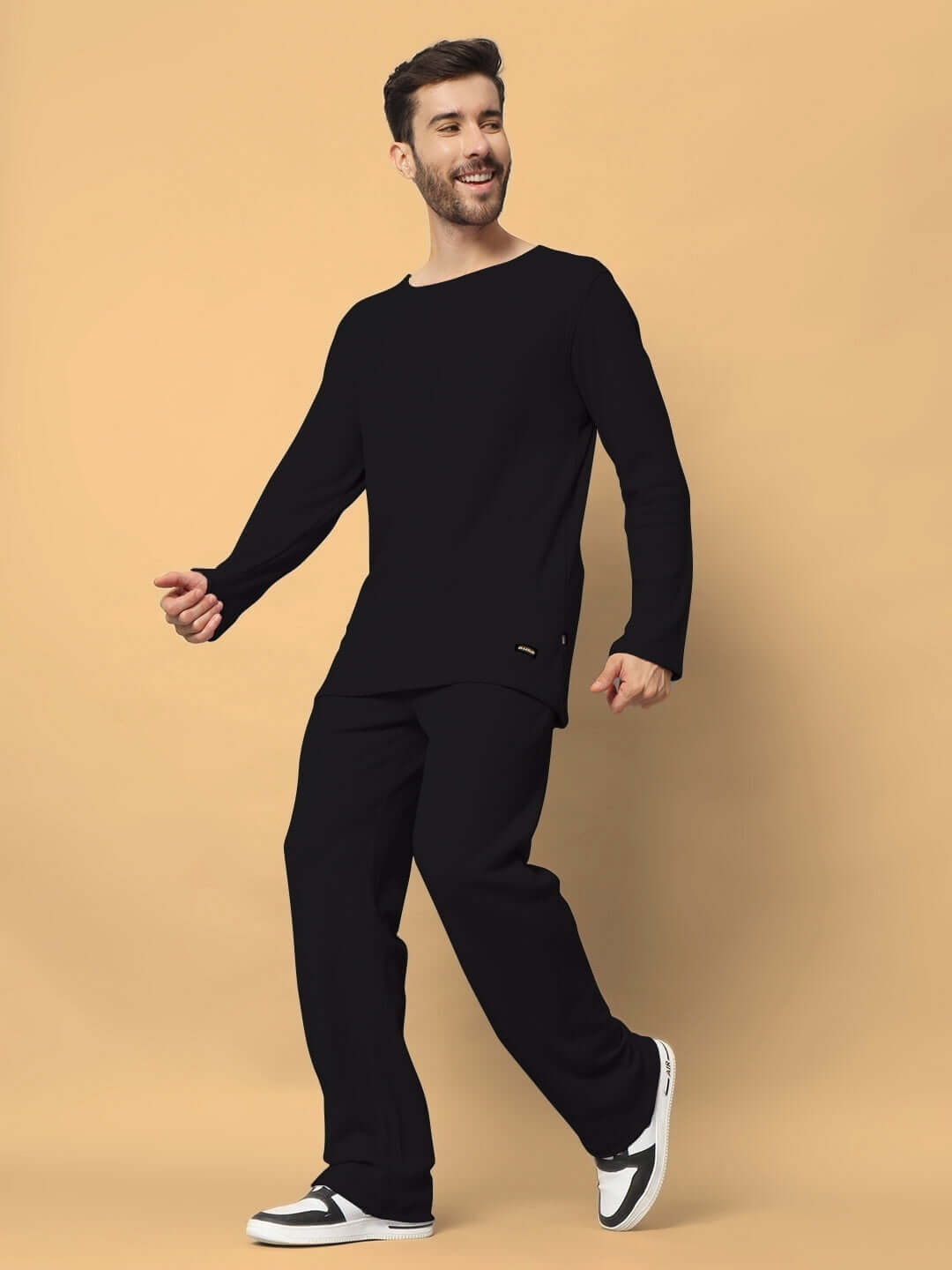 Model wearing Vogue oversized black co-ord set with relaxed fit joggers, made of 100% cotton waffle fabric, unisex design.