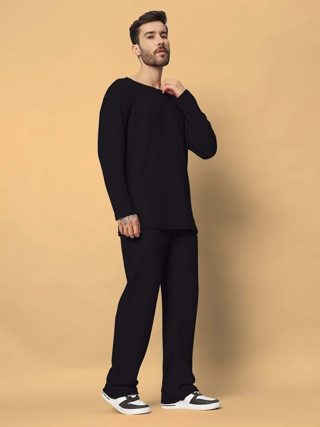 Model wearing Vogue oversized black co-ord set with relaxed fit joggers.