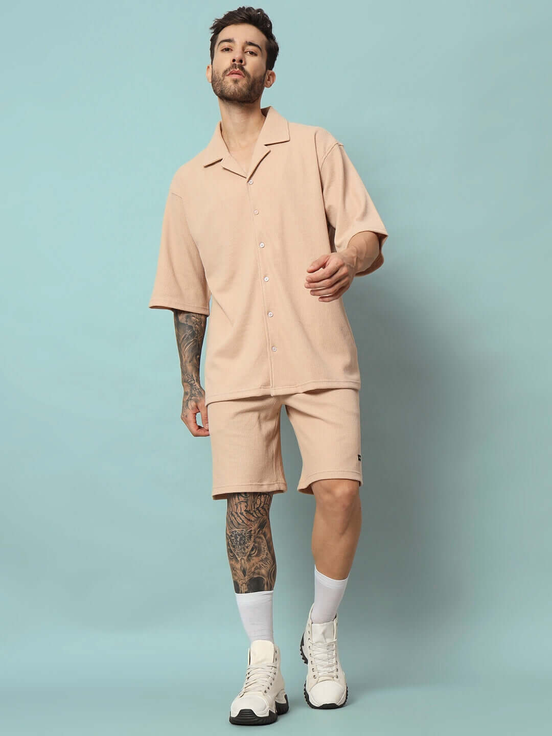 Model wearing beige Waffle Solid Resort Shirt Co-ord Set in 100% cotton with half sleeves and relaxed fit, standing against a blue backdrop.