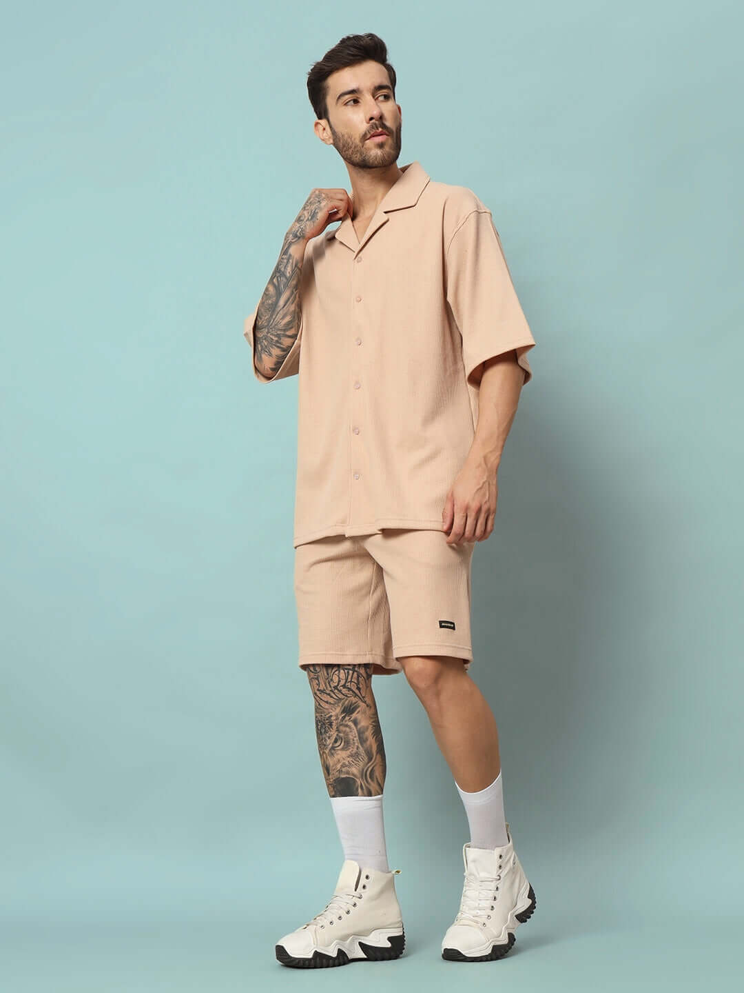 Model wearing beige waffle fabric resort shirt and shorts co-ord set, relaxed fit, half sleeves, 100% cotton. Perfect for casual wear.