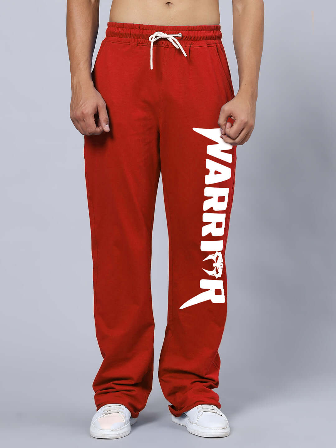 WARRIOR PRINTED COTTON TERRY JOGGER RED displayed against a gray background, showcasing the bold white WARRIOR print on the side.