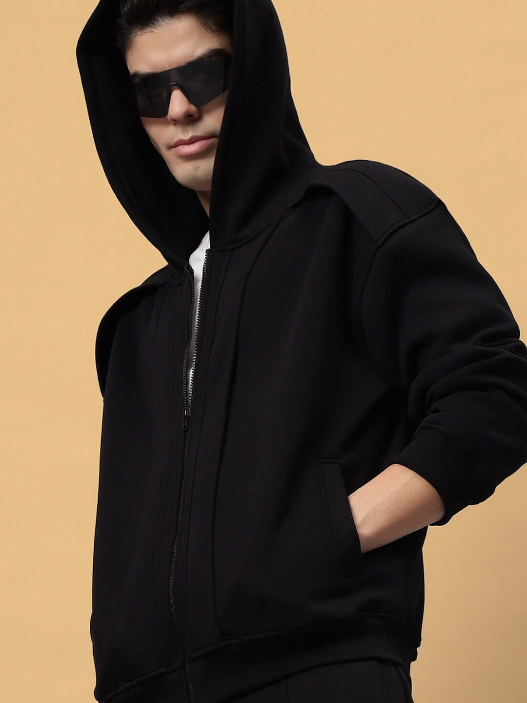 Man wearing WD ADMIRE COTTON FLEECE HOODIE BLACK with sunglasses, showcasing cozy and stylish design with a spacious hood and kangaroo pocket.