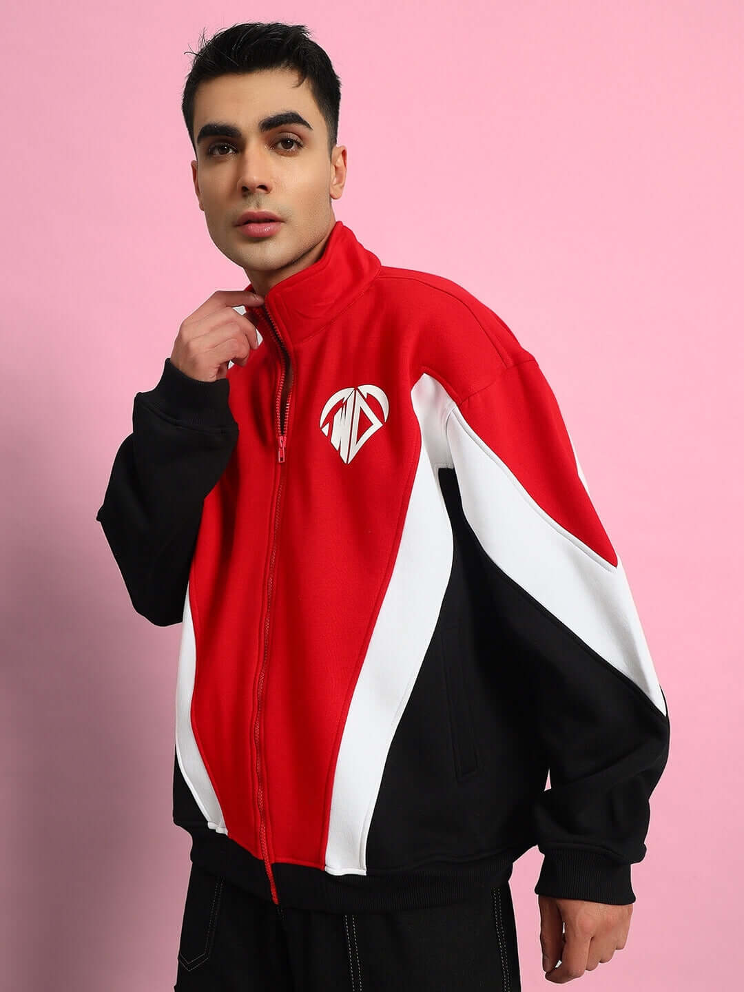 Model wearing WD Alfa Colorblock Jacket in red, designed by DUDS, against pink background; made-to-order fashion item with custom fit option.