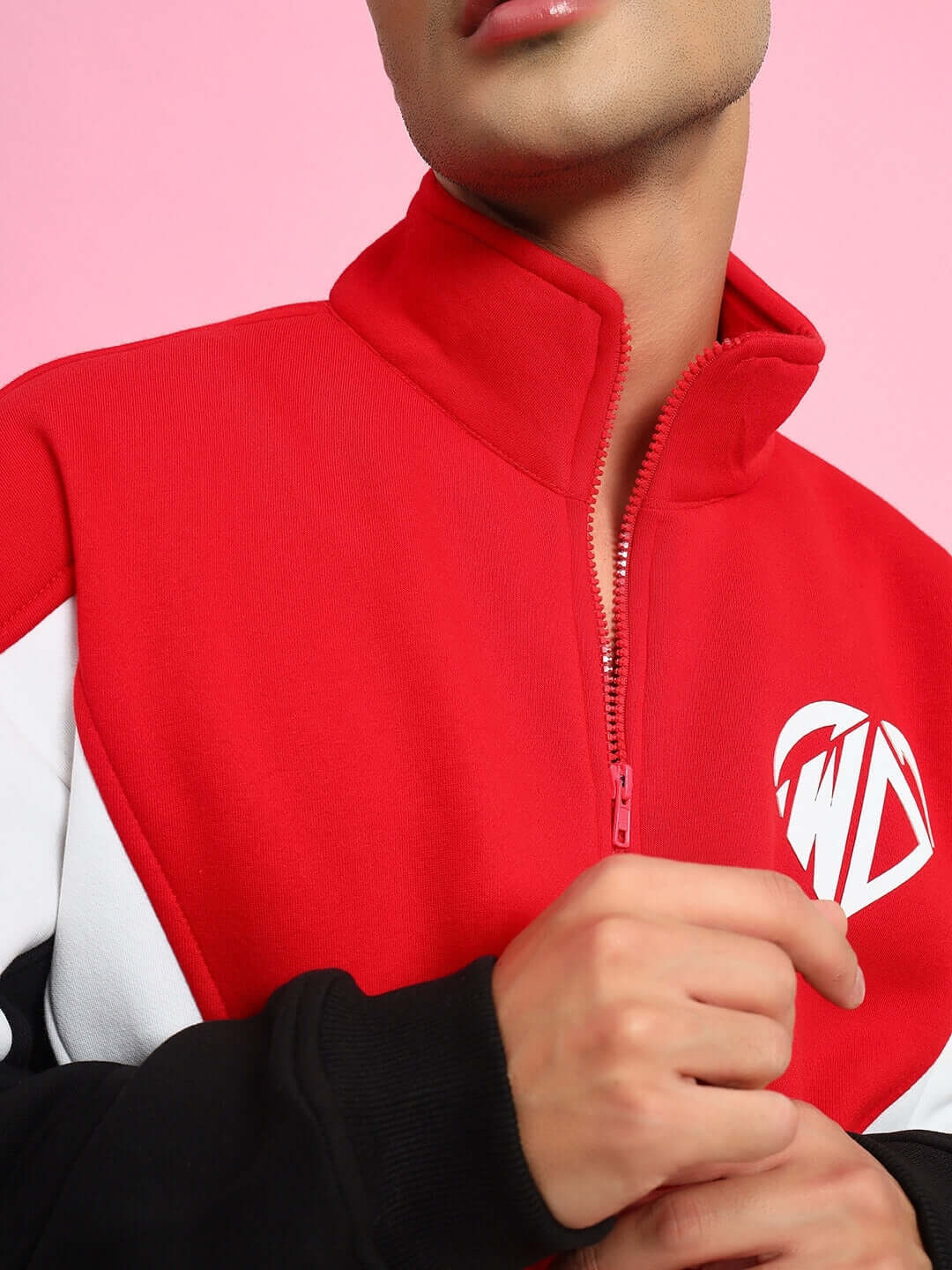 Person wearing WD ALFA Colorblock Jacket in red with white logo detail, close-up of design and zipper