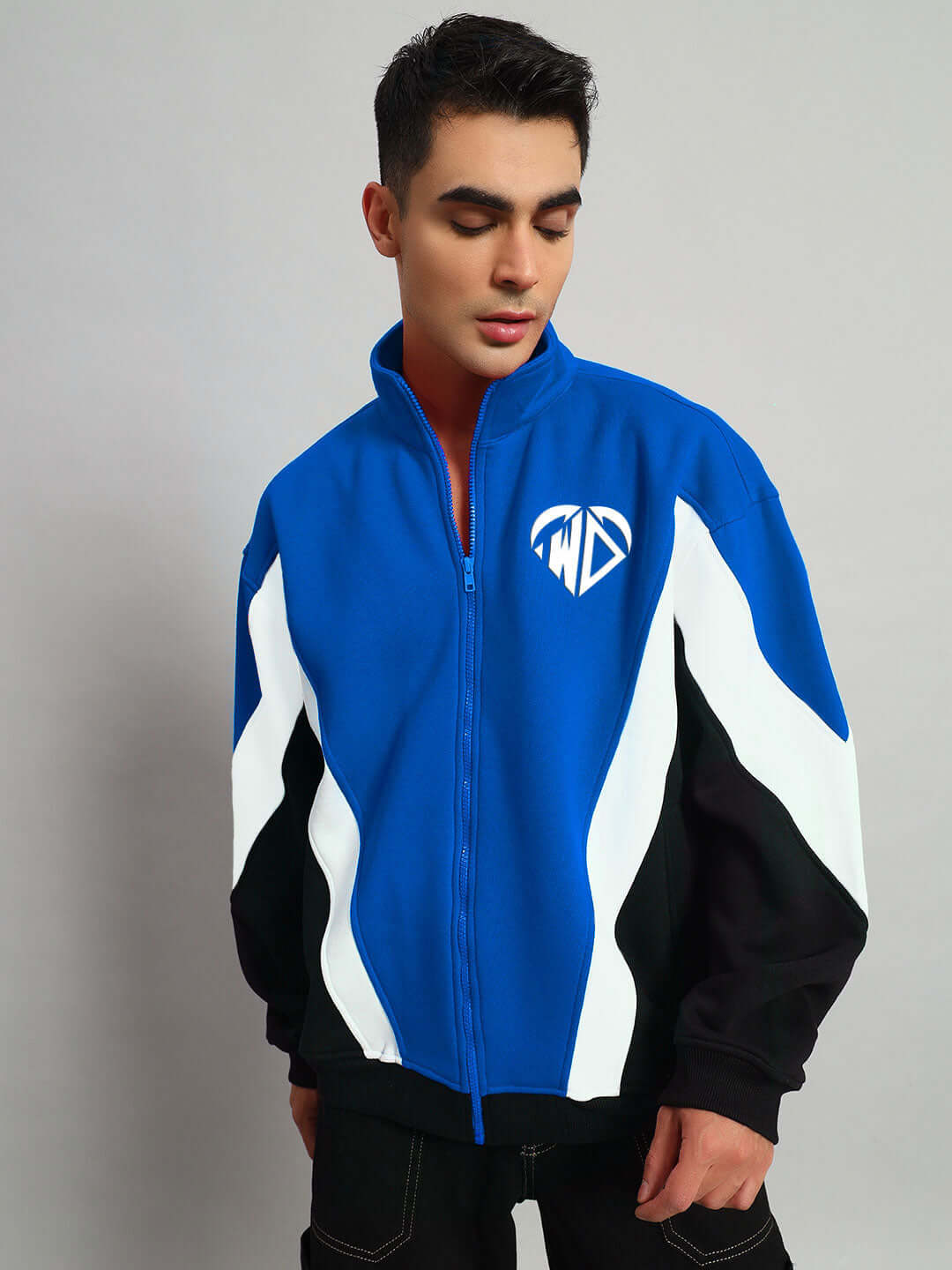Model wearing WD ALFA Fleece Colorblock Jacket in blue, featuring white and black accents, designed for a stylish and customizable fit.