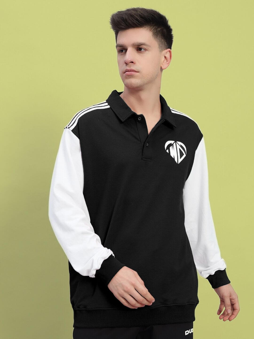 Man wearing WD Corvus sweatshirt in black and white, featuring premium cotton fabric, bio-washed for softness, made in India.